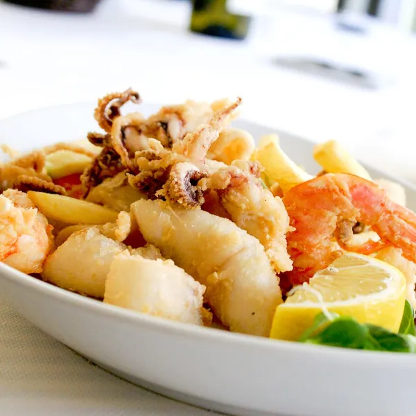 Plate of fried calamari and seafood with lemon