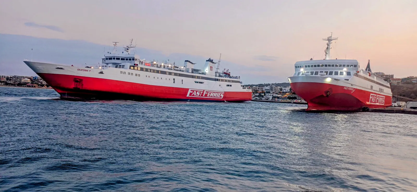 Two Fast Ferries docked in Rafina port at golden hour